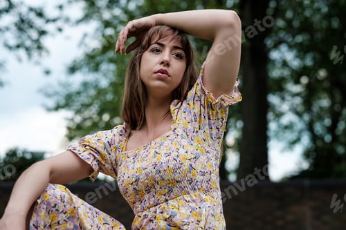 Preview: Portrait of young woman on spring dress in a park.