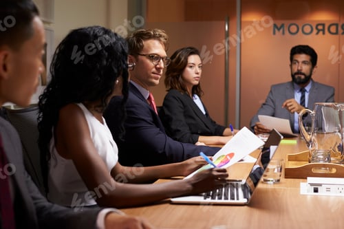 Preview: Business people at an evening boardroom meeting, close up