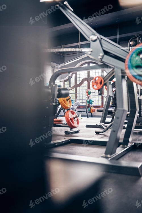 Preview: Gym interior, fitness and exercise with gym equipment and weightlifting for body training, health a