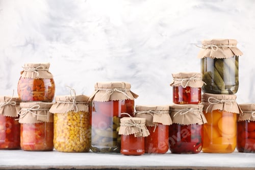 Preview: Many jars with different pickled products on light table. Space for text