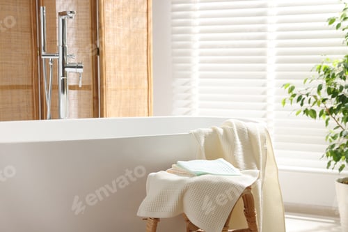 Preview: Clean waffle towels on table near bath indoors