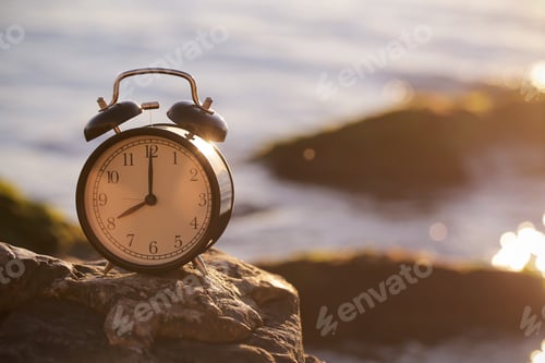 Preview: Clock Alarm Clock Stand On The Sea In The Evening At Sunset