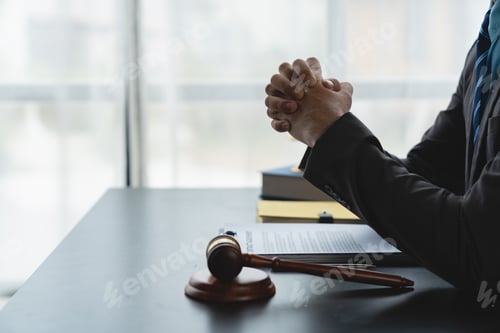 Preview: Young lawyer or legal advisor sitting holding hands thinking Carefully consider investment documents