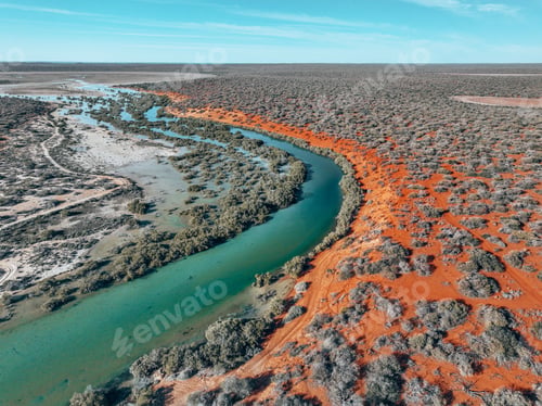 Preview: Aerial view of a river winding through a desert landscape.