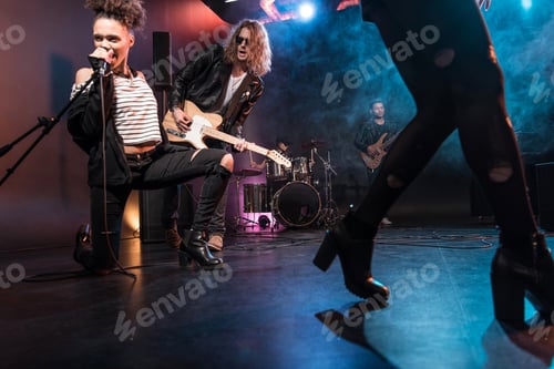 Preview: Young multiethnic rock and roll band performing concert on stage