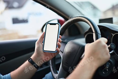 Preview: Close up Hands of unrecognizable man driver using white screen mockup mobile phone while driving