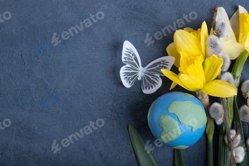 Preview: Globe, flowers and butterfly with copy space. Happy Earth day concept flat lay, top view.