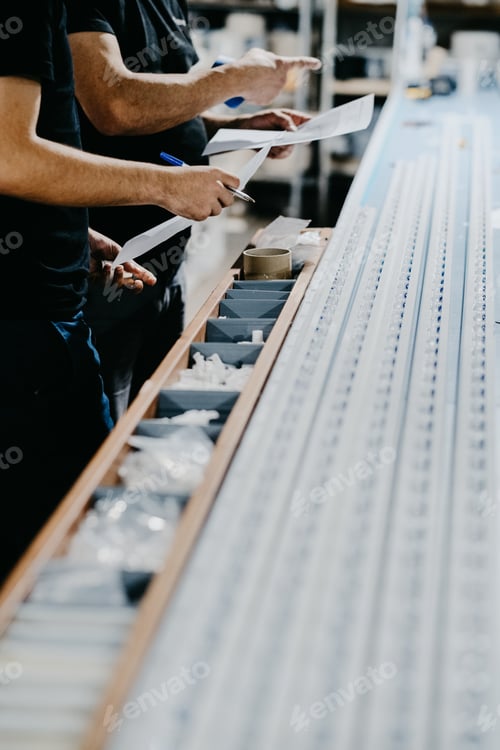 Preview: Vertical shot of a person working with machine tools in a factory