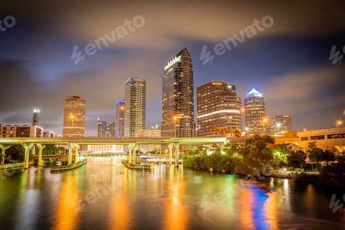 Preview: Skyline of downtown Tampa on the Hillsborough river at night under a blue sky
