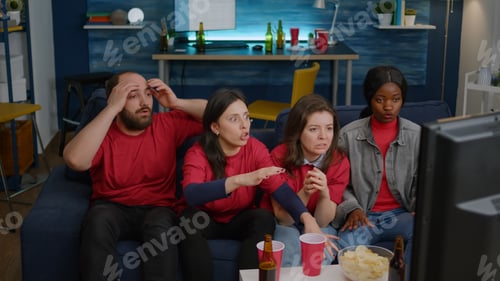 Preview: Competitive multiethnic fans watching football game during sport championship