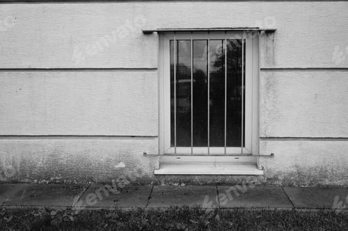 Preview: Window with metal frames on a building made of white stones