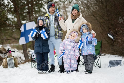 Preview: Finnish family with Finland flags on a nice winter day. Nordic Scandinavian people.