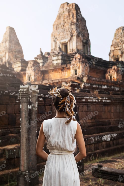 Preview: Young woman wearing white robe dress in ancient Khmer ruins, Angkor Wat