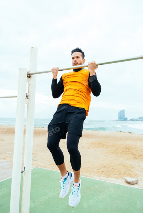 Preview: Young athlete training in the morning on the beach at the gym