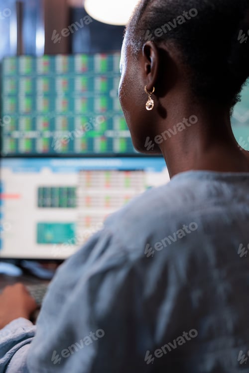 Preview: Close up shot of stock trading expert sitting in front of multi monitor workstation