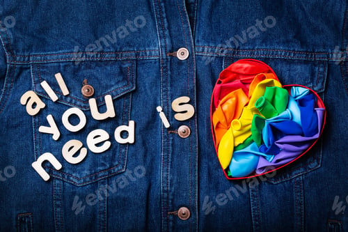 Preview: Heart shaped rainbow lgbtq flag against denim background, pride month