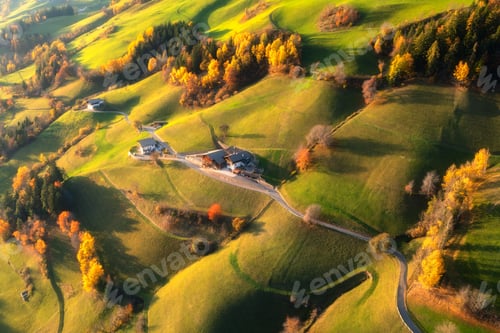 Preview: Aerial view of amazing green alpine meadows, orange trees, hills