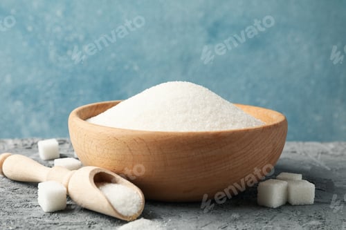 Preview: Bowl and scoop with sugar on grey table, space for text