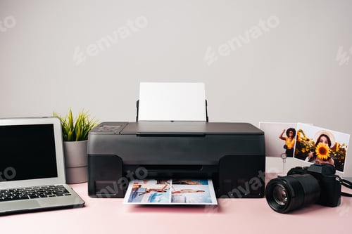 Preview: Printer, laptop and camera on table close up. Printing photos