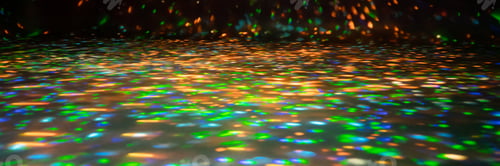 Preview: blurred rays of light on disco floor. orange green blue neon searchlight lights. laser lines and lig