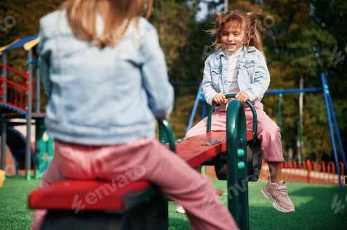 Preview: Autumn season. Kids are having fun on the playground