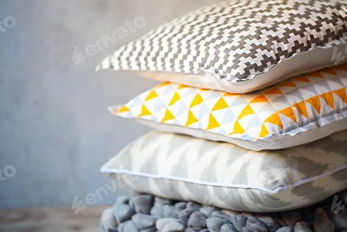 Preview: Yellow and grey pillows on the wall background