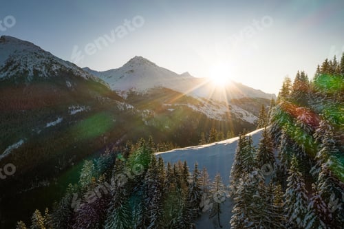 Preview: Sun shining over the snowy mountains in Sainte-Foy-Tarentaise, French Alps