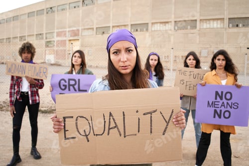 Preview: Feminist with a banner at a protest. Women activist demonstration.
