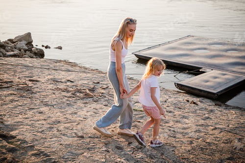 Preview: Walking along the Drava River on a summer evening in Osijek, Croatia with a child
