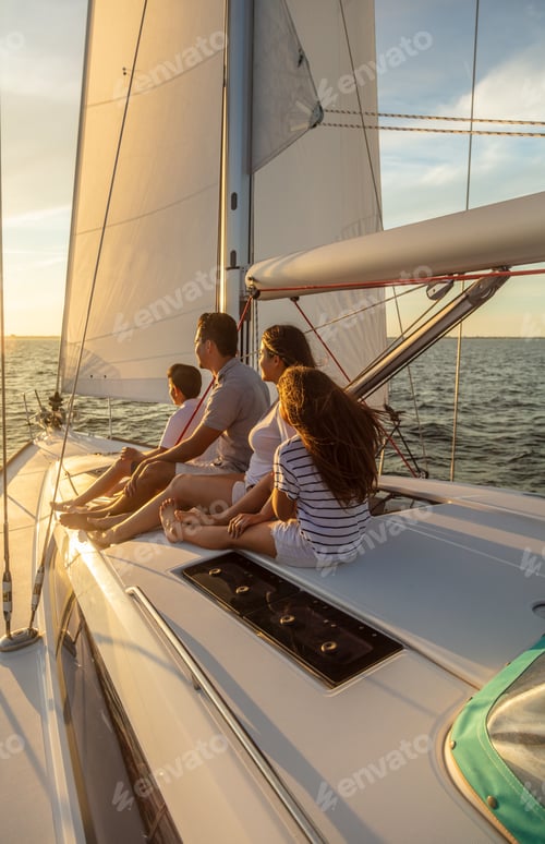 Preview: Latin American family relaxing on yacht at sunset