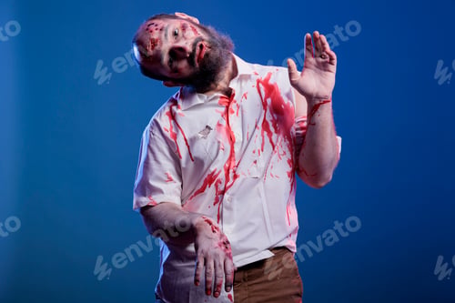 Preview: Horror looking scary zombie growling at camera, studio background