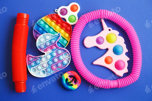Preview: colorful antistress sensory fidget toys on a blue background.