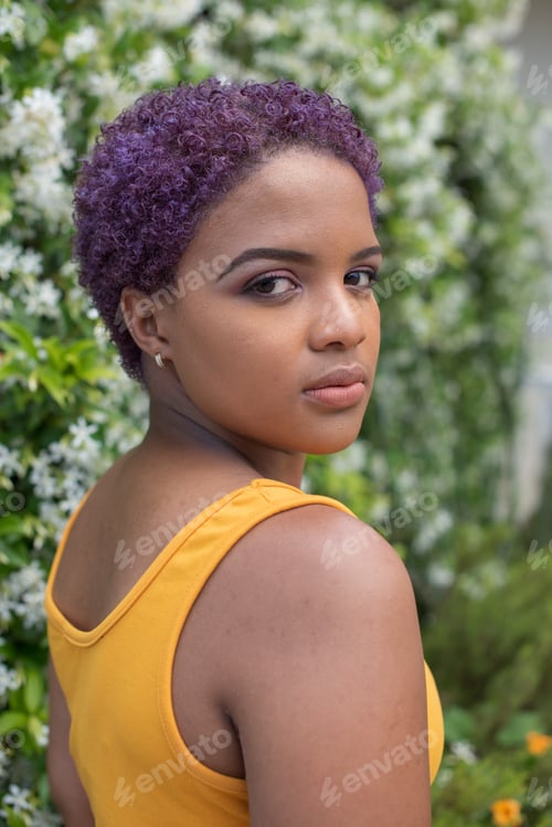 Preview: Portrait of young woman with colorful hair looking backwards
