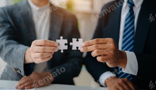 Preview: Business solutions and success concept. Businessman hand connecting jigsaw puzzle at office
