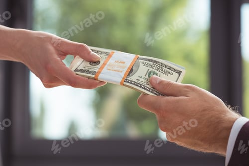 Preview: cropped view of businesspeople holding dollar banknotes, salary concept