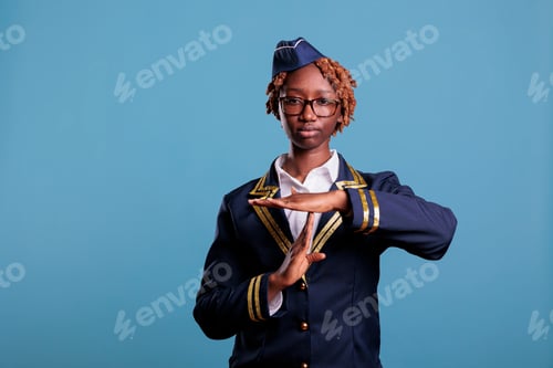 Preview: flight attendant gesturing time out and pause in studio