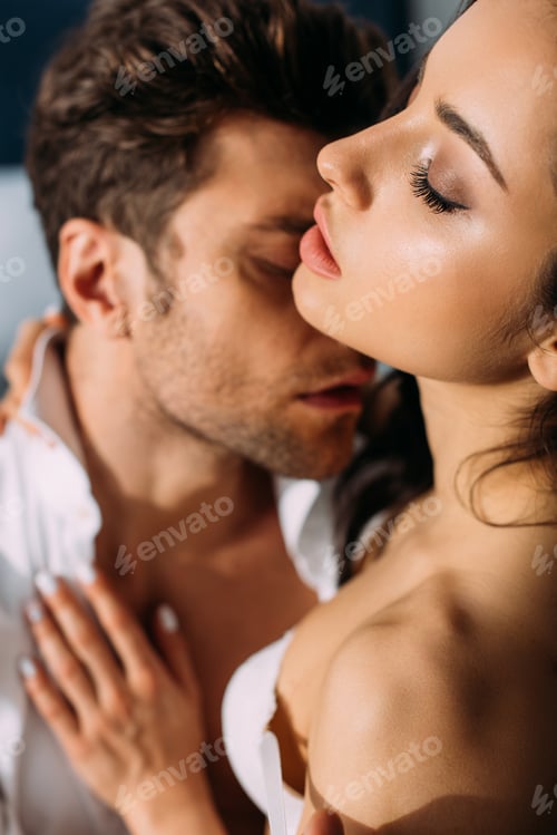 Preview: Selective focus of passionate woman with closed eyes hugging businessman