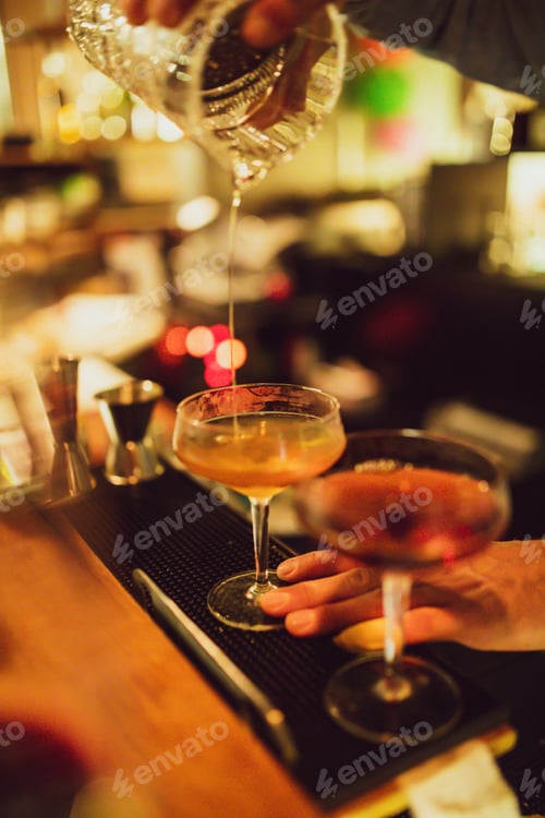 Preview: Vertical shot of a glass being filled with an alcoholic beverage in the pub