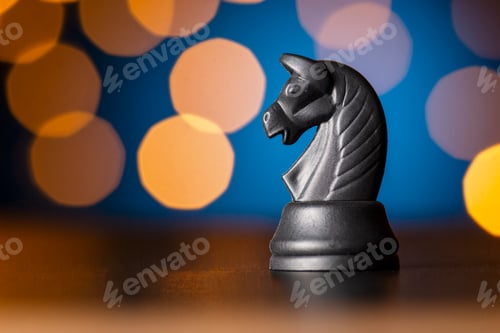 Preview: black horse chess piece over a colorful bokeh