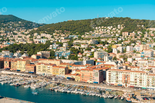 Preview: Aerial view of Nice coastal city with colorful buildings and The Nice Port marina filled with boats