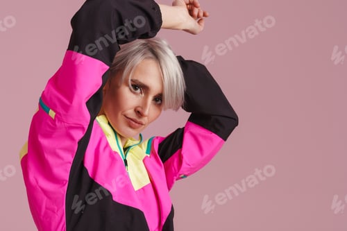 Preview: White-haired woman in multicolored jacket dancing on camera