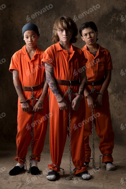 Preview: Studio portrait of three boys in handcuffs and chains