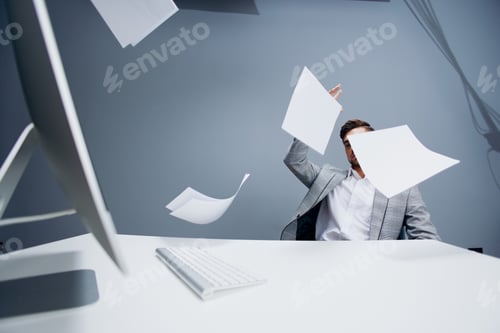 Preview: manager working at the computer in the office scatters documents executive