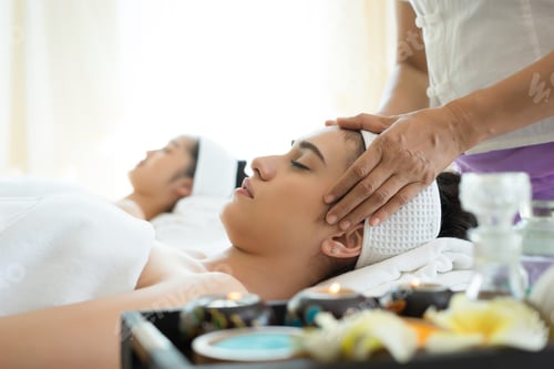 Preview: Young beautiful woman having face massage relaxing in spa.