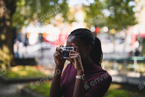 Preview: Woman taking photos with a vintage film camera