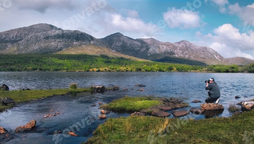 Preview: Beautiful landscape scenery with photographer by th Lough Inagh with mountains in the background at