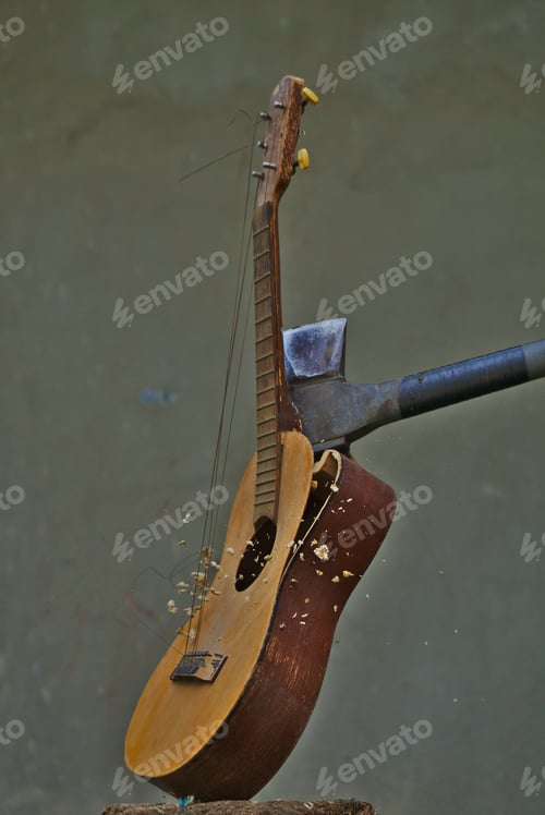 Preview: Vertical image of an axe smashing an acoustic guitar