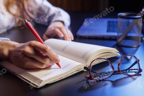 Preview: Writing in a Notebook with a Red Pen