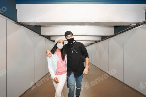 Preview: Young interracial couple of lovers in a subway corridor.