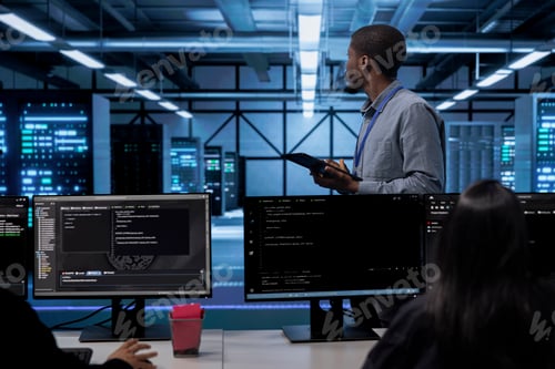 Preview: IT worker in server room monitoring server infrastructure